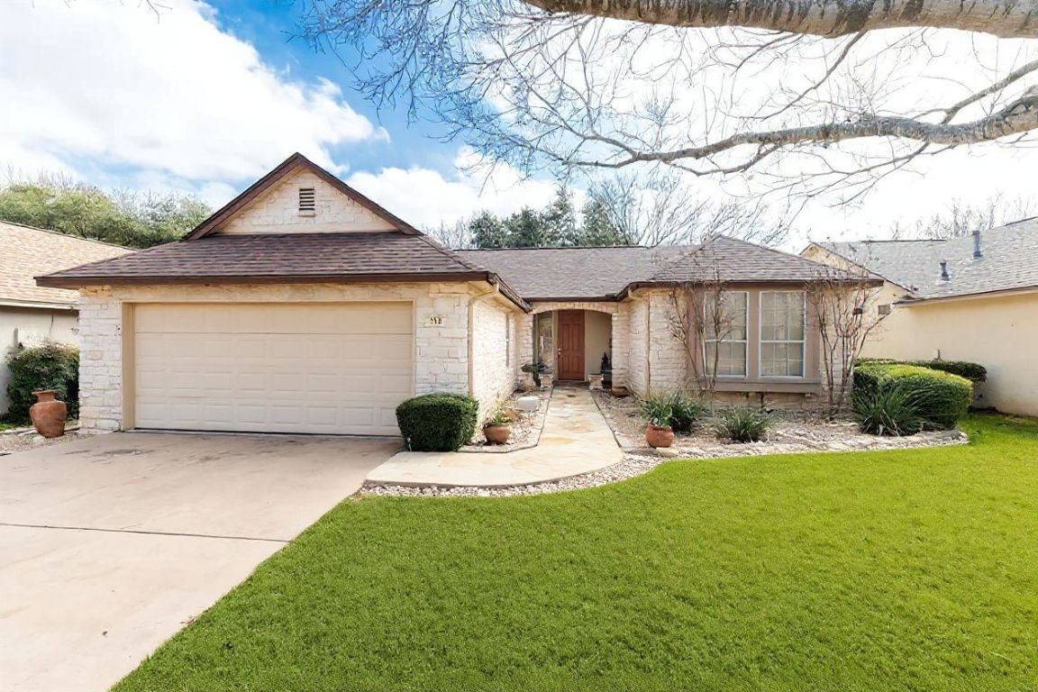 View of front facade featuring roof with shingles, driveway, a front lawn, and an attached garage