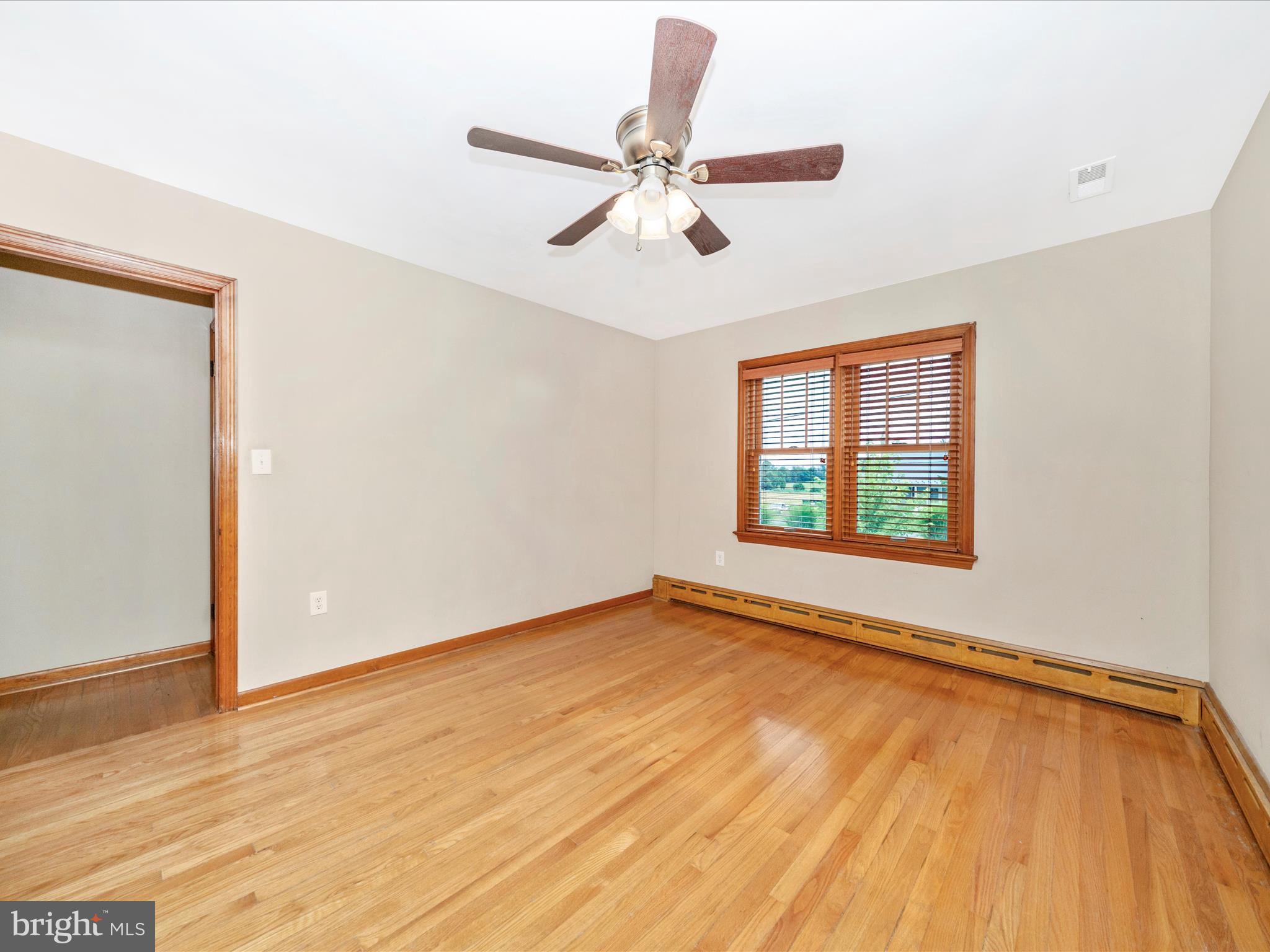 9523 Liberty Road Frederick, MD 21701 - Photo 19 of 51 a view of an empty room with a window and wooden floor