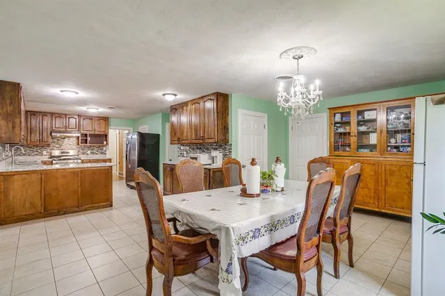 a view of a dining room with furniture and chandelier