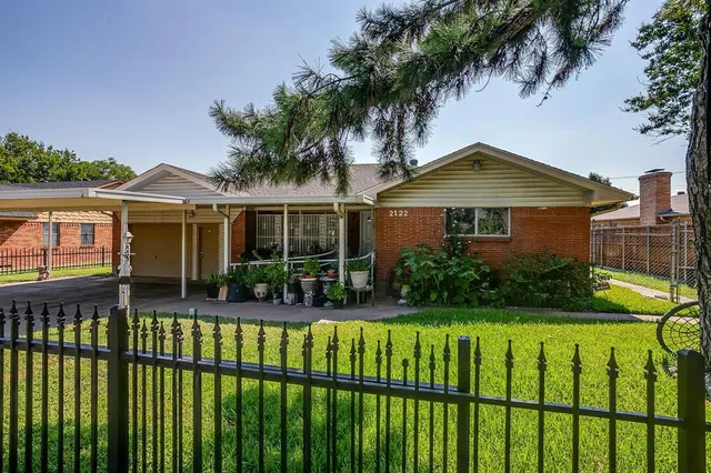 a front view of a house with a yard table and chairs