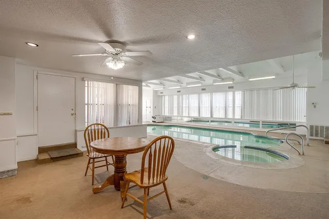 a kitchen with a dining table chairs and white cabinets