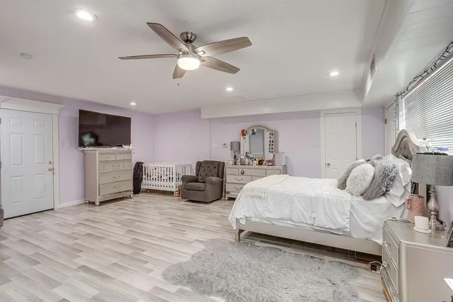 a bedroom with furniture and a large window