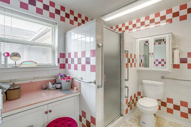 a bathroom with a sink toilet and shower