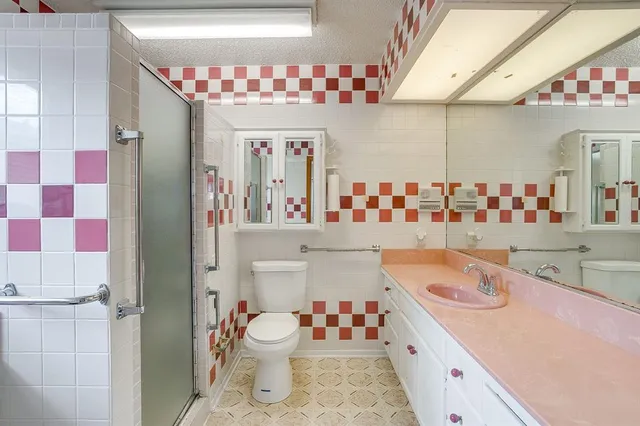 a bathroom with a sink toilet and shower