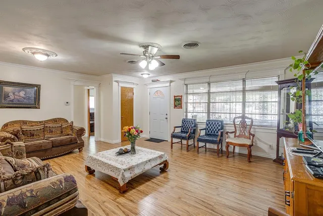 a living room with furniture and wooden floor