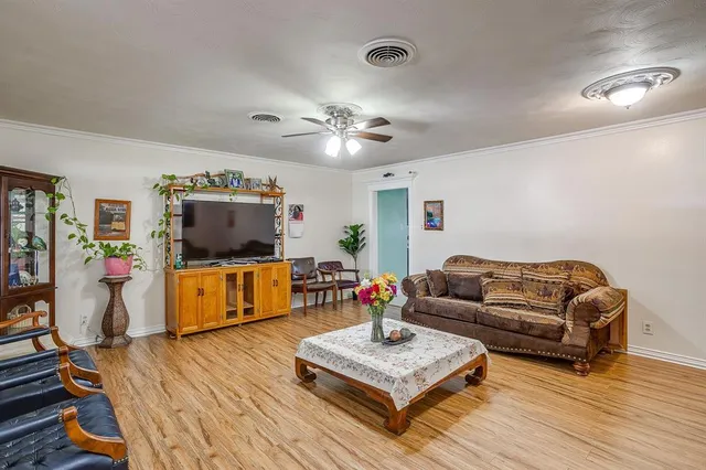 a living room with furniture a flat screen tv and a table