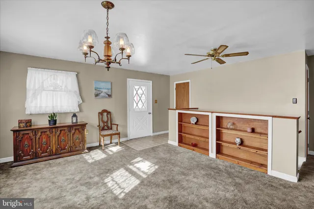 a view of a livingroom with furniture cabinets and wooden floor