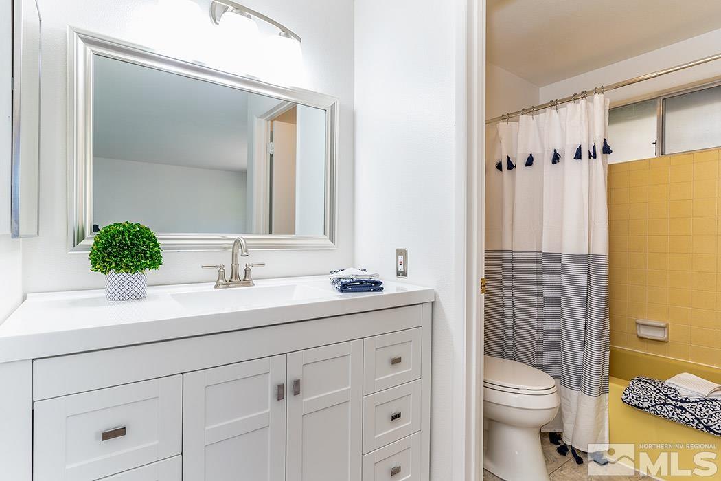 3685 Renee Way Reno, NV 89503 - Photo 12 of 26 a bathroom with a sink a toilet a shower and a mirror