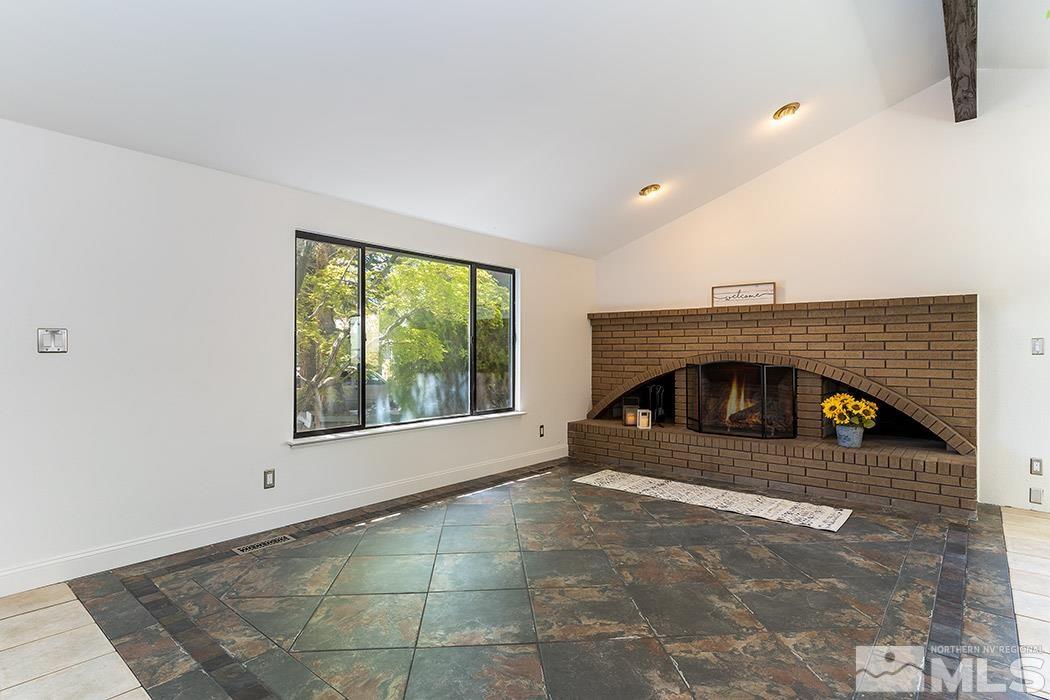 3685 Renee Way Reno, NV 89503 - Photo 3 of 26 a view of an empty room with a fireplace and a window