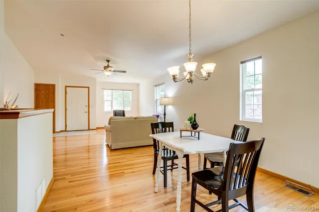 a view of a dining room with furniture and wooden floor