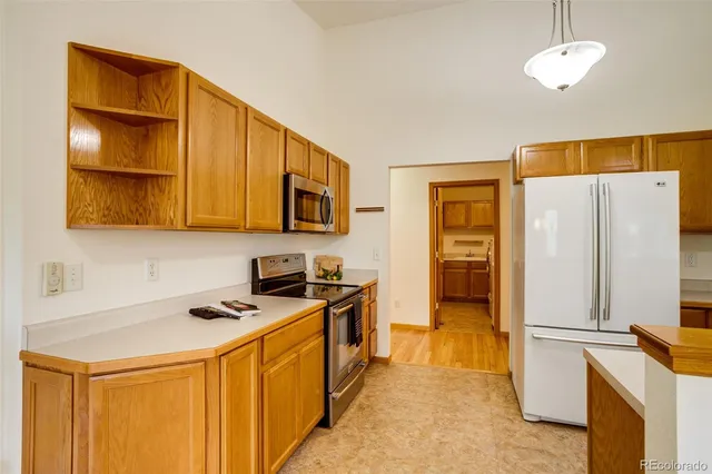a kitchen with stainless steel appliances a refrigerator stove and microwave