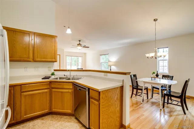 a kitchen with a sink a counter space and dining table