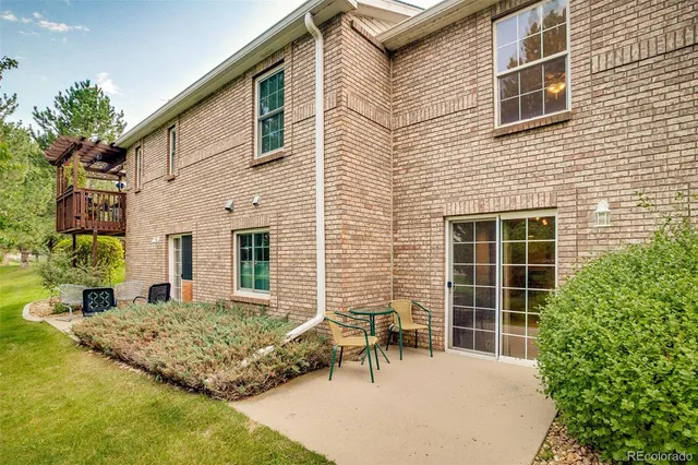 a backyard of a house with table and chairs