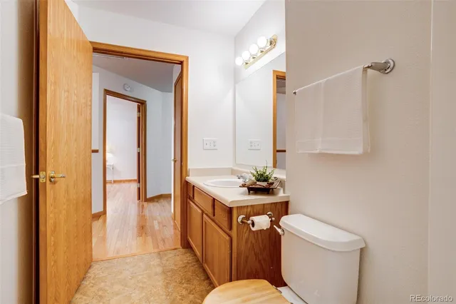 a bathroom with a toilet sink and mirror