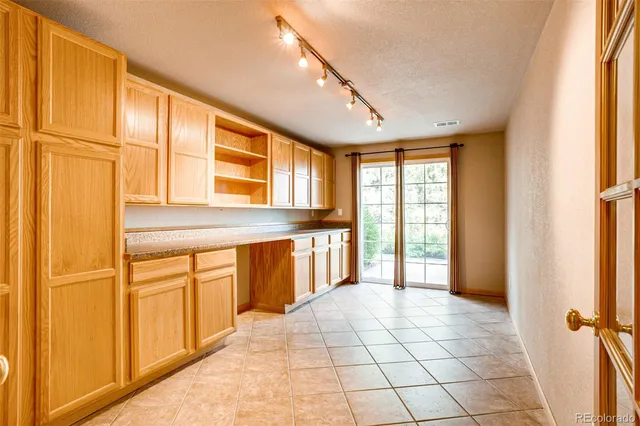 a view of a kitchen with a sink and windows