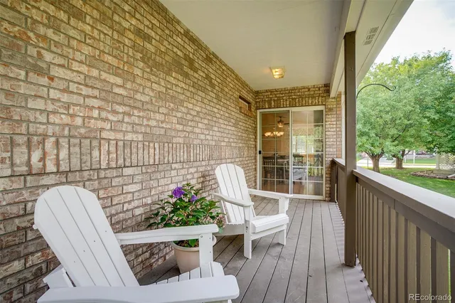 a view of a chair and tables in the balcony