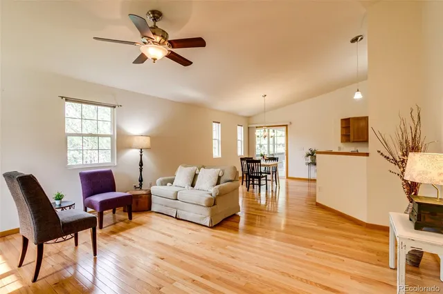 a living room with furniture and kitchen view