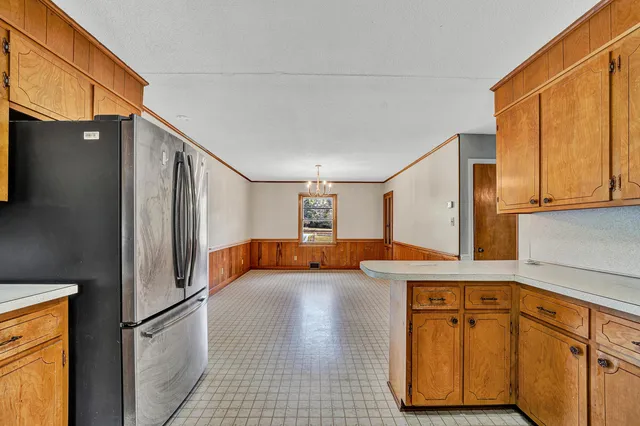 a kitchen with stainless steel appliances granite countertop a refrigerator and a stove top oven