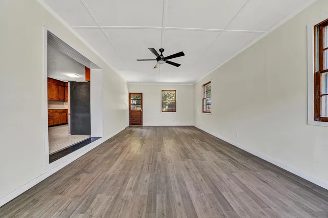 wooden floor in an empty room with a window