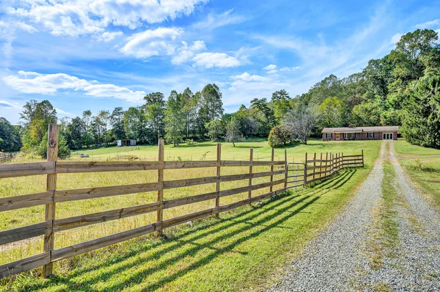 a view of a yard with wooden fence
