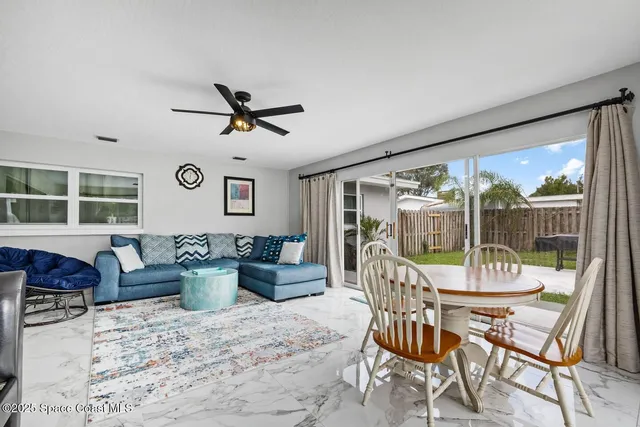 a living room with furniture and kitchen view