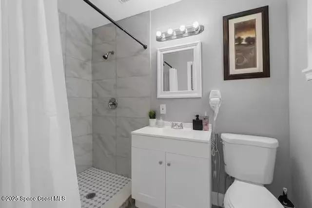 a white bed sitting in a room next to a window