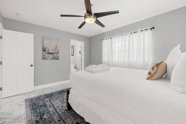 a bedroom with a bed and a table in it