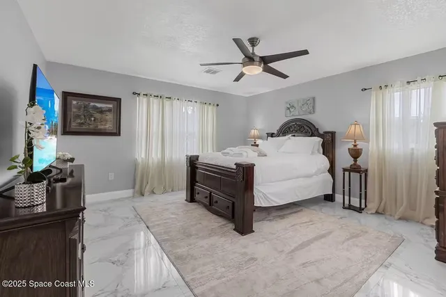 a bed room with a bed and a chandelier