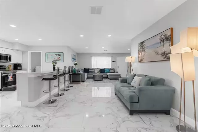 a kitchen with stainless steel appliances kitchen island a refrigerator and cabinets
