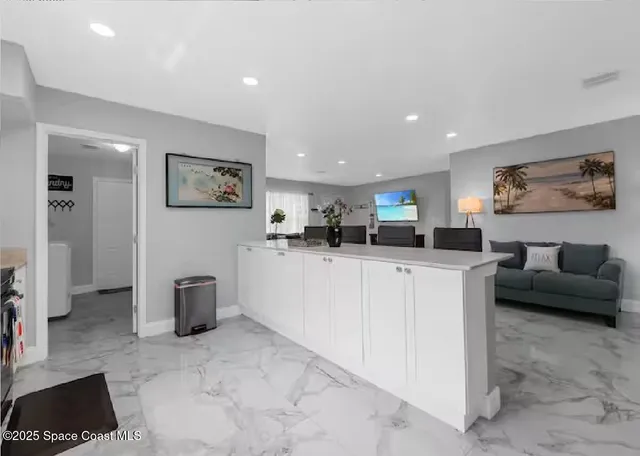 a kitchen with stainless steel appliances granite countertop a stove and a microwave