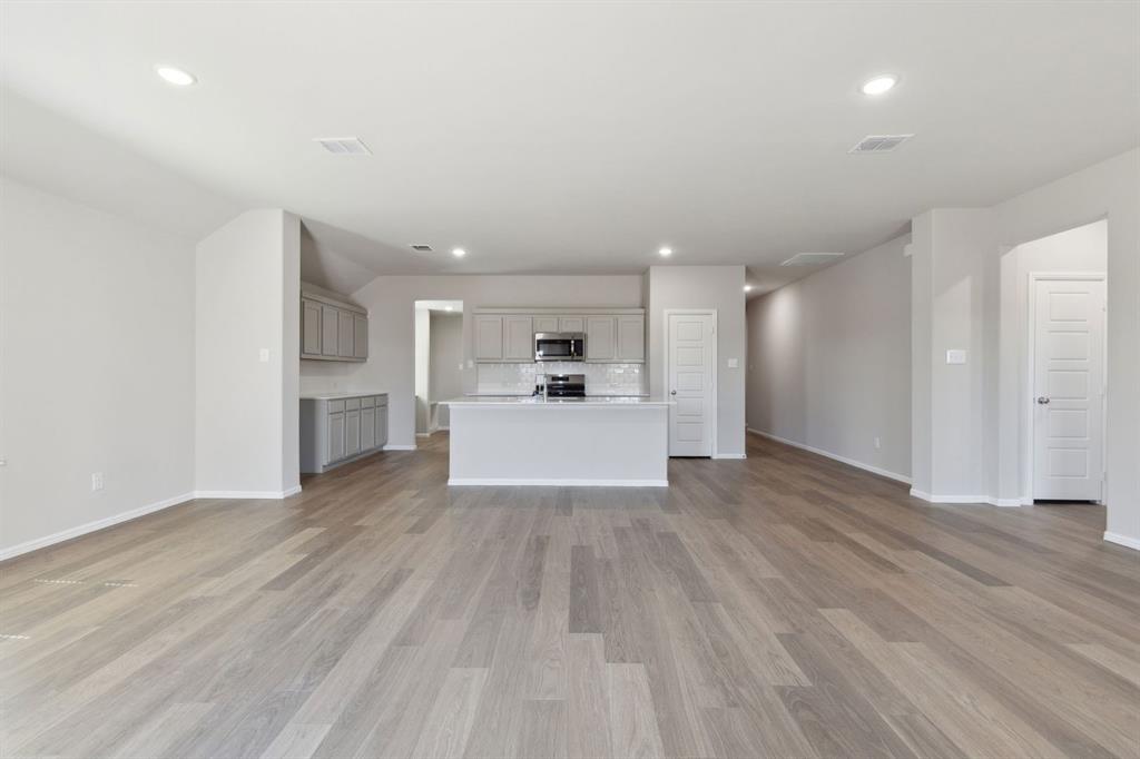 1122 Sunward Road Princeton, TX 75407 - Photo 34 of 36 a view of a kitchen with wooden floor and a kitchen