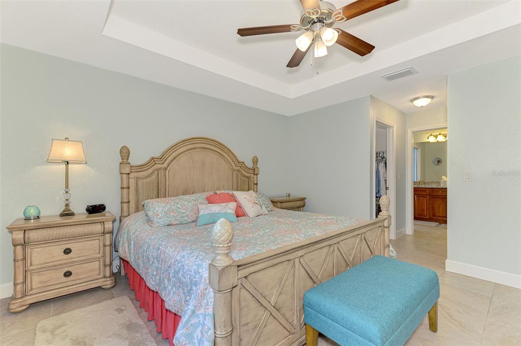 13049 Ridgely Circle Port Charlotte, FL 33981 - Photo 11 of 49 a bedroom with a bed and a dresser