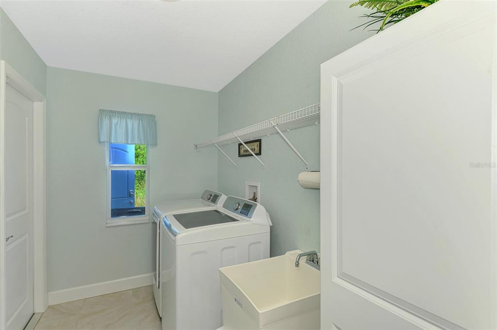 13049 Ridgely Circle Port Charlotte, FL 33981 - Photo 21 of 49 a utility room with a sink dryer and washer