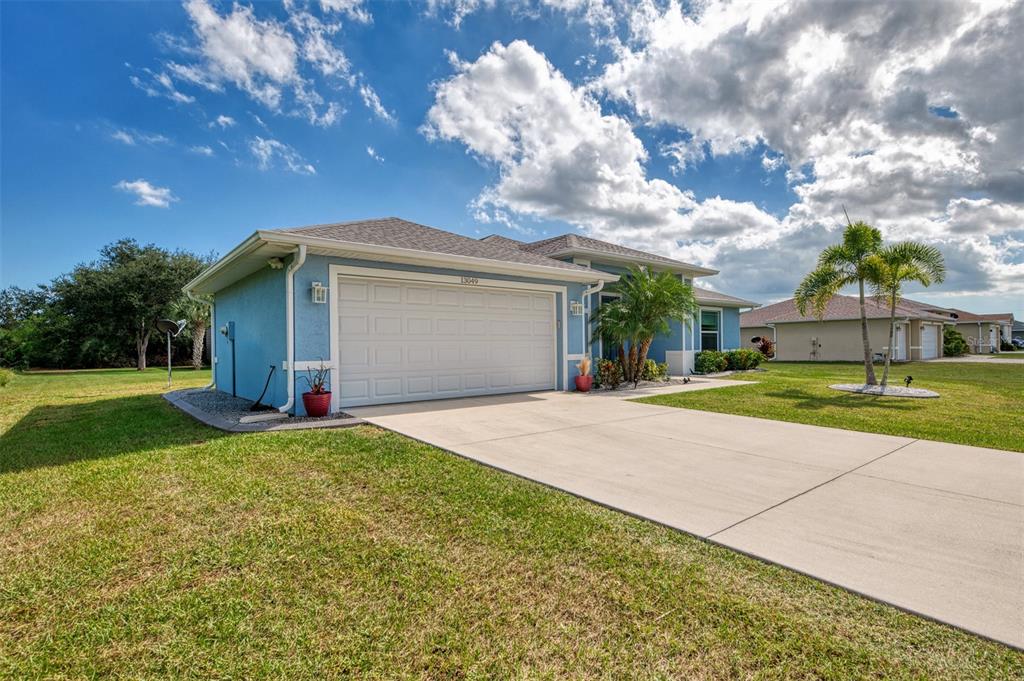 13049 Ridgely Circle Port Charlotte, FL 33981 - Photo 31 of 49 a view of a house with backyard and tree