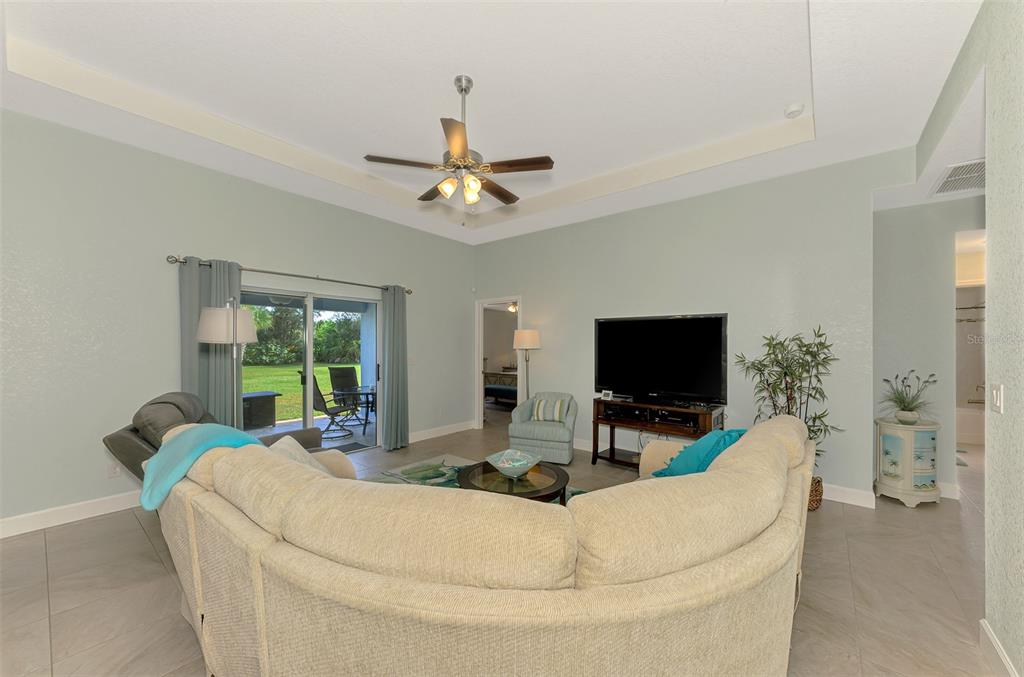 13049 Ridgely Circle Port Charlotte, FL 33981 - Photo 33 of 49 a living room with furniture and a flat screen tv
