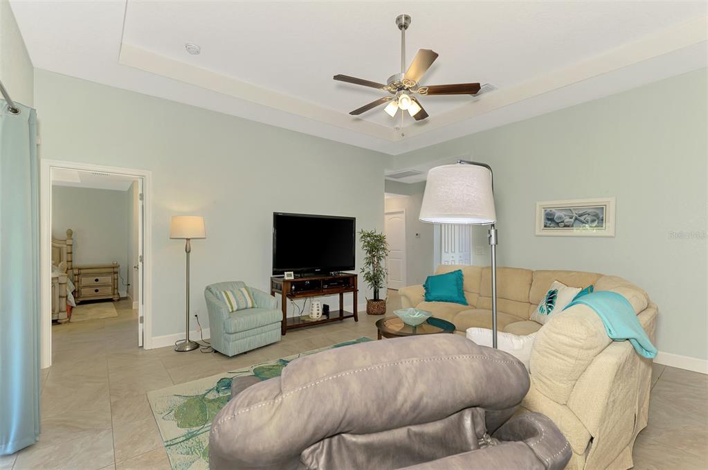 13049 Ridgely Circle Port Charlotte, FL 33981 - Photo 34 of 49 a living room with furniture and a flat screen tv