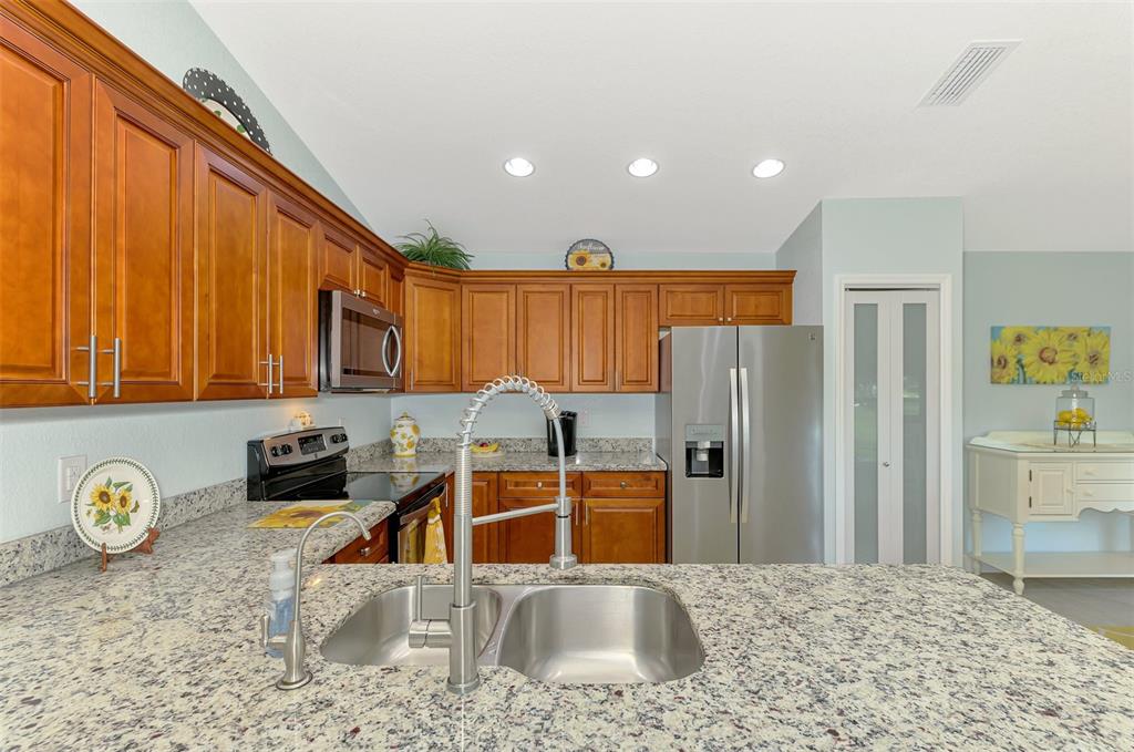 13049 Ridgely Circle Port Charlotte, FL 33981 - Photo 38 of 49 a kitchen with stainless steel appliances granite countertop a refrigerator and a sink