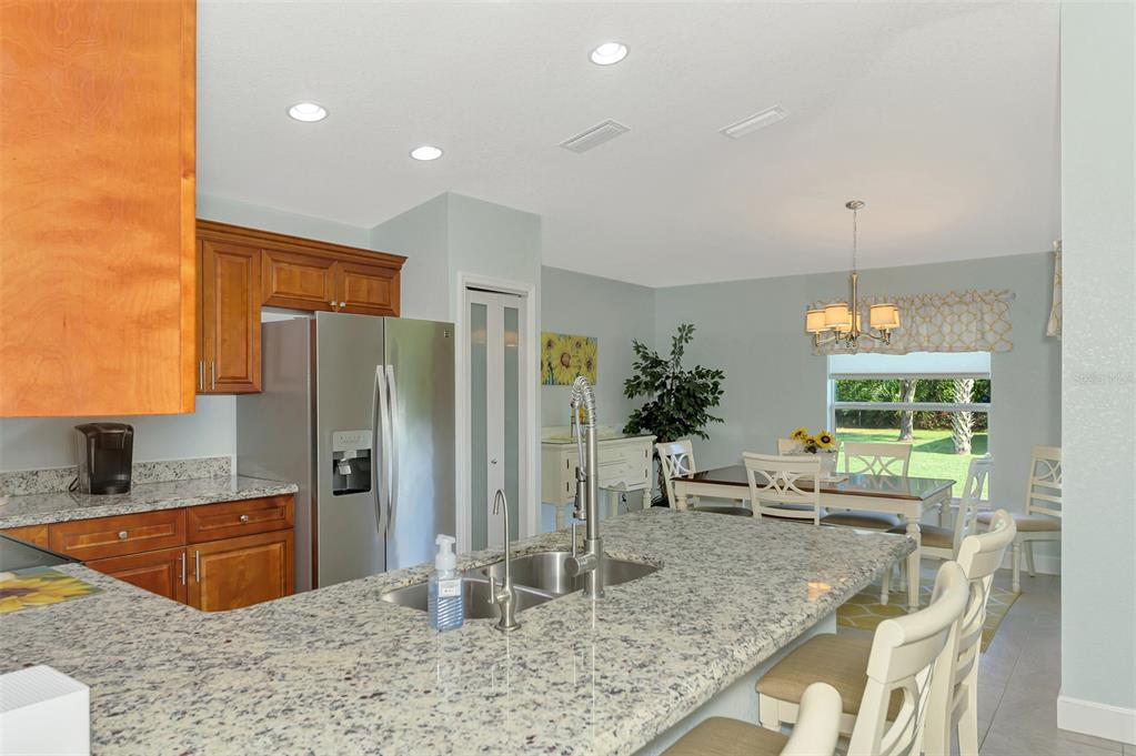 13049 Ridgely Circle Port Charlotte, FL 33981 - Photo 39 of 49 a kitchen with stainless steel appliances granite countertop a sink refrigerator and cabinets