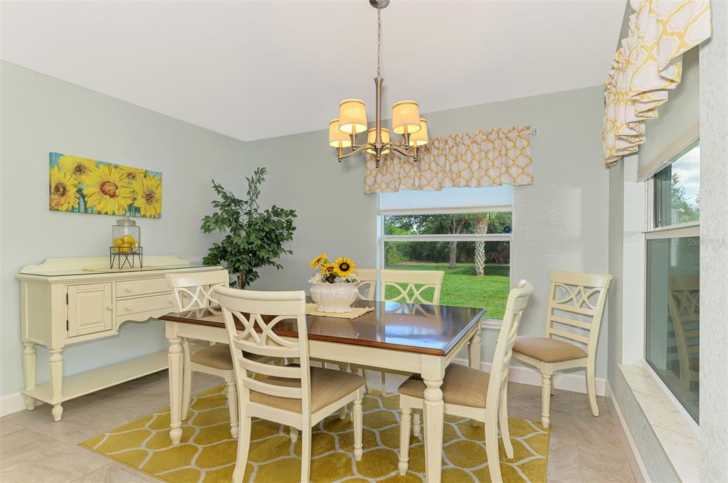 13049 Ridgely Circle Port Charlotte, FL 33981 - Photo 46 of 49 a dining room with furniture a chandelier and window