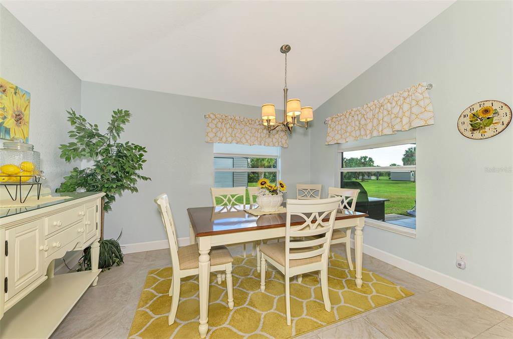 13049 Ridgely Circle Port Charlotte, FL 33981 - Photo 47 of 49 a dining room with furniture a chandelier and window