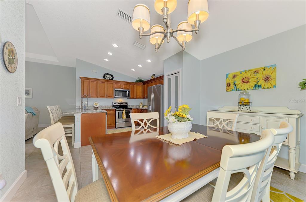 13049 Ridgely Circle Port Charlotte, FL 33981 - Photo 8 of 49 a living room with lots of furniture and kitchen view