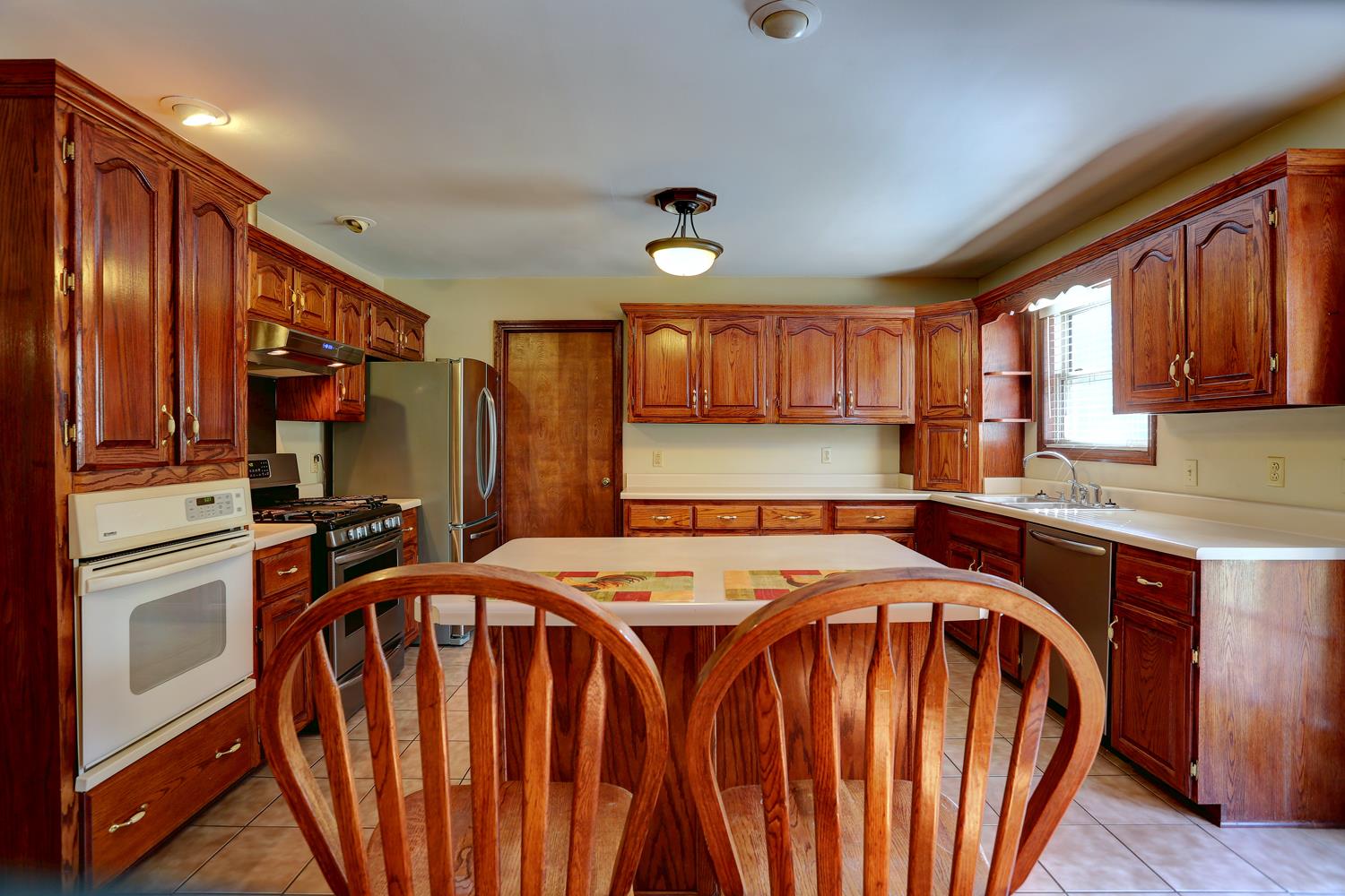 4809 Charles Dorris Road Springfield, TN 37172 - Photo 23 of 27 a kitchen that has a lot of cabinets in it wooden cabinets and stainless steel appliances