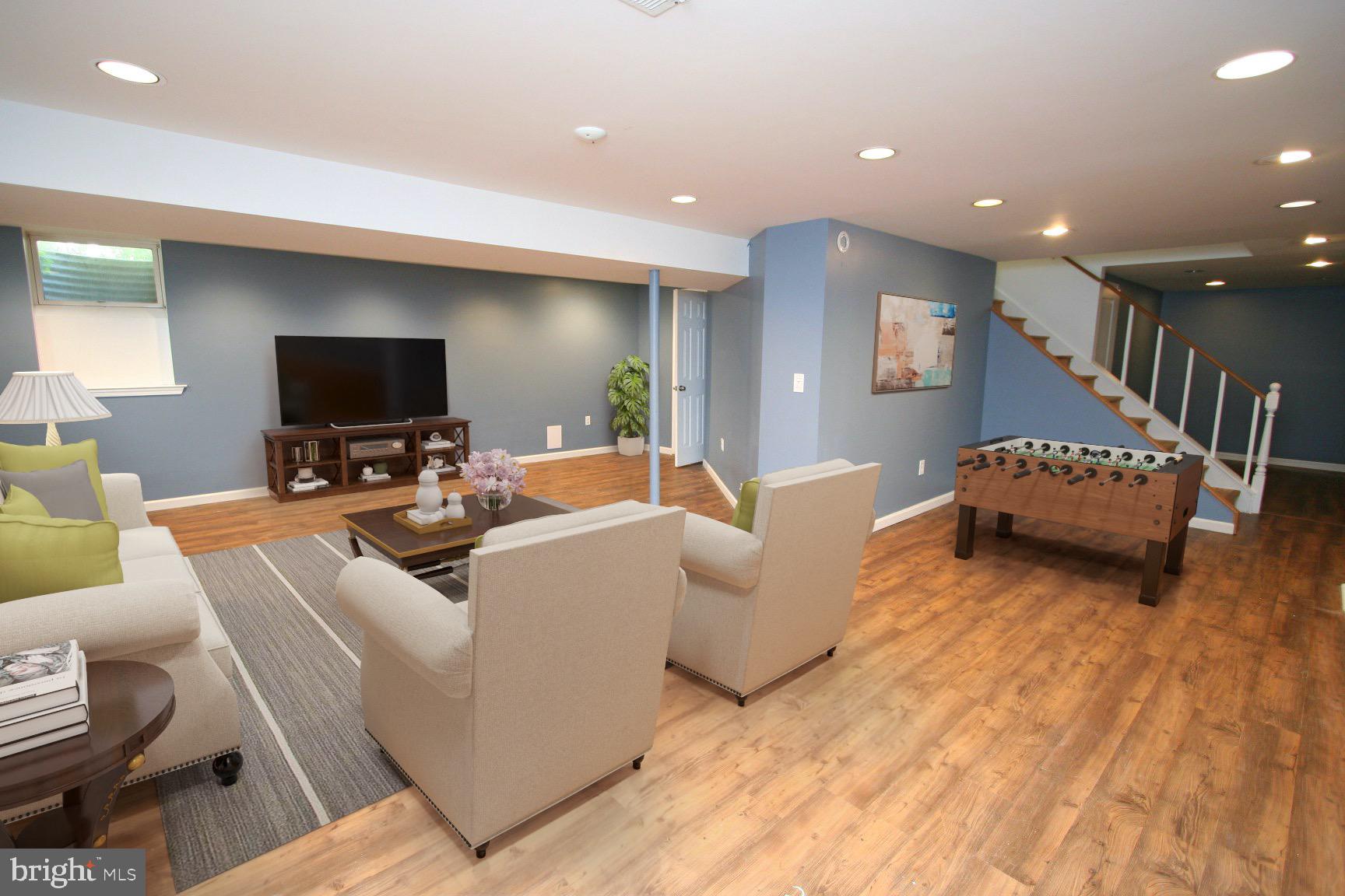 1908 Rainbow Drive Silver Spring, MD 20905 - Photo 14 of 14 a living room with furniture and a flat screen tv