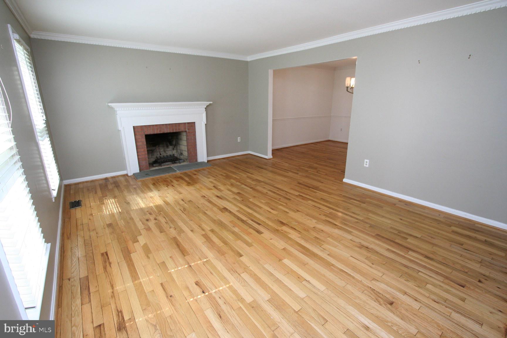 1908 Rainbow Drive Silver Spring, MD 20905 - Photo 8 of 14 a view of empty room with wooden floor and fireplace