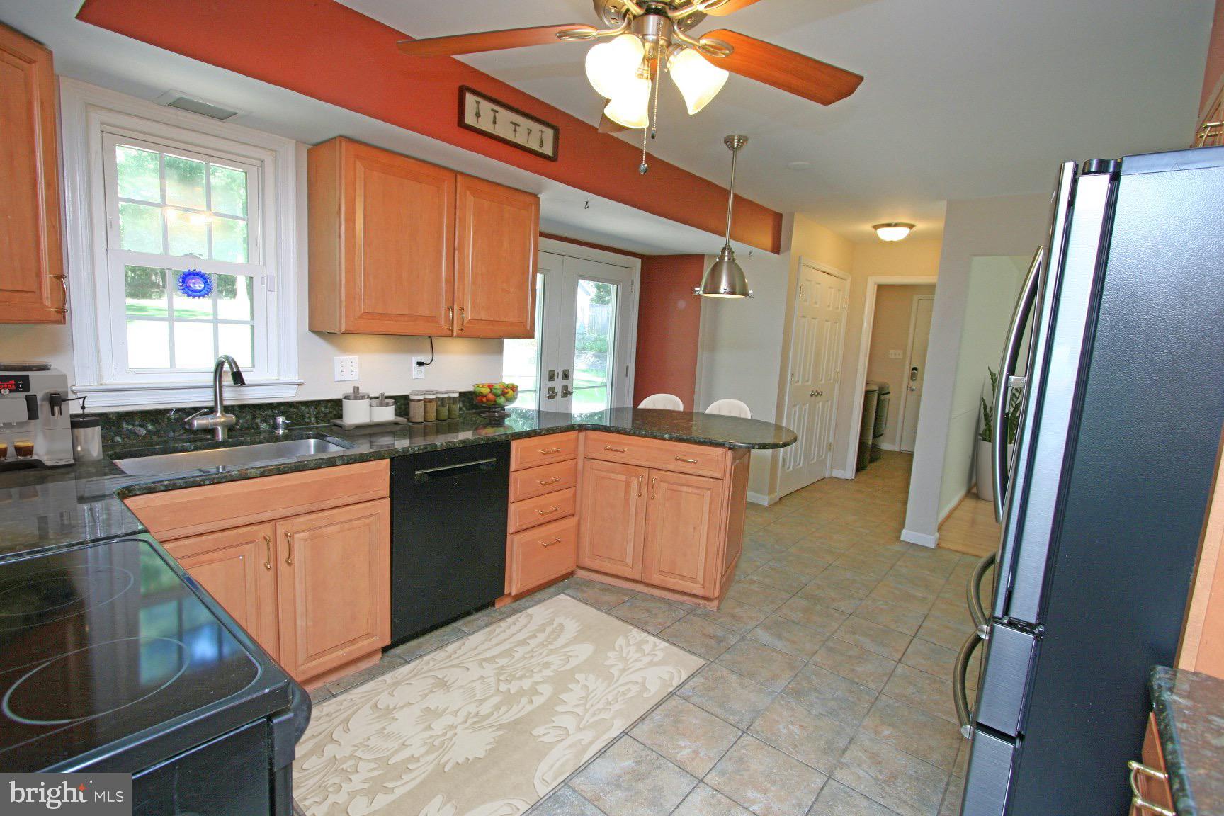1908 Rainbow Drive Silver Spring, MD 20905 - Photo 10 of 14 a kitchen with stainless steel appliances granite countertop a stove a sink and a refrigerator