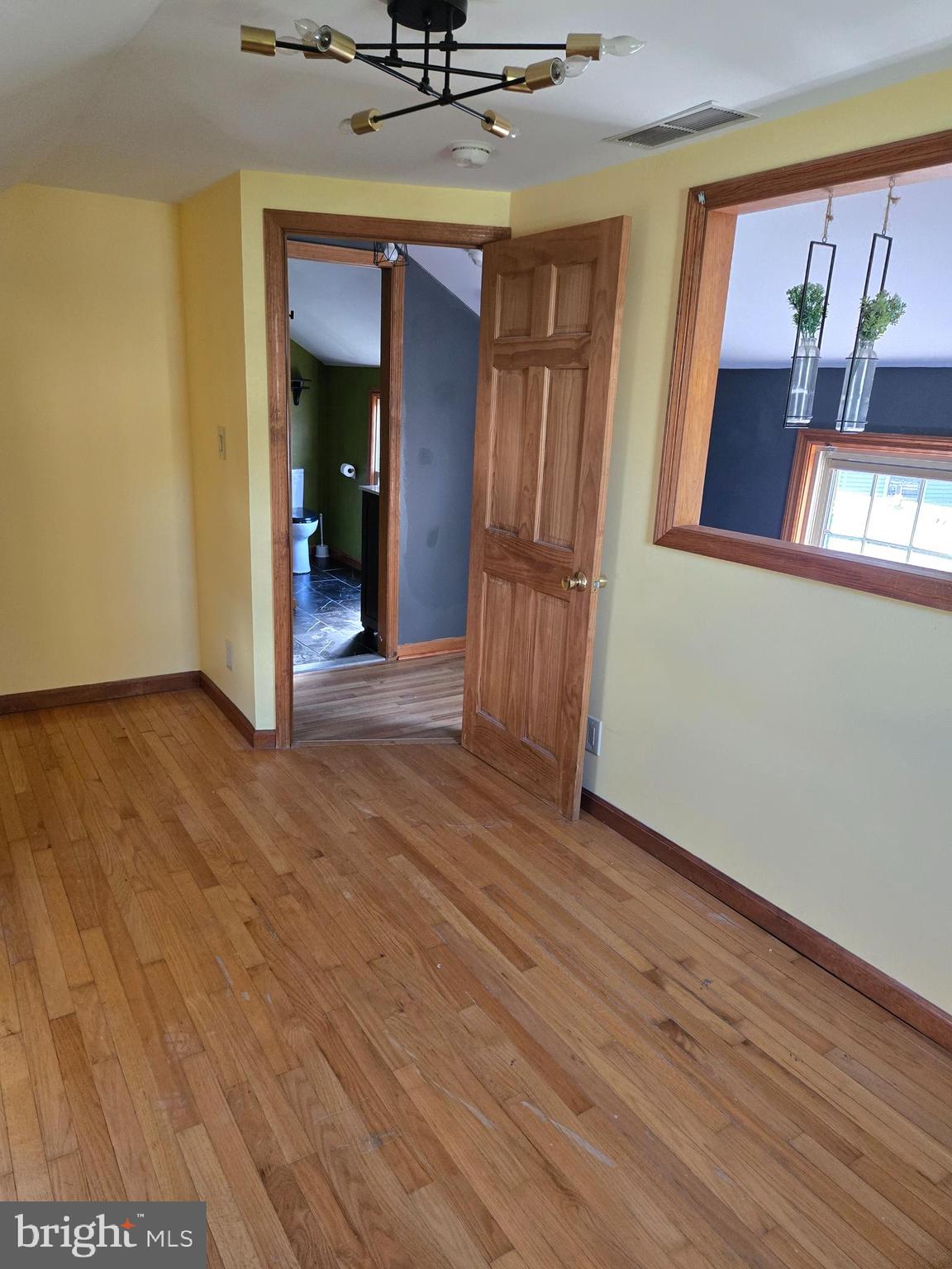 127 3rd Avenue Pitman, NJ 08071 - Photo 14 of 15 a view of an empty room with wooden floor and a window