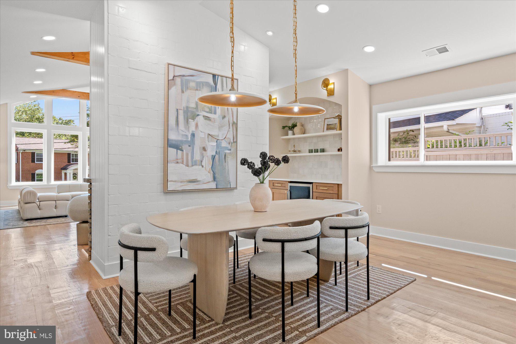 6125 Overlea Road Bethesda, MD 20816 - Photo 16 of 61 a kitchen with stainless steel appliances kitchen island granite countertop a table chairs and a refrigerator