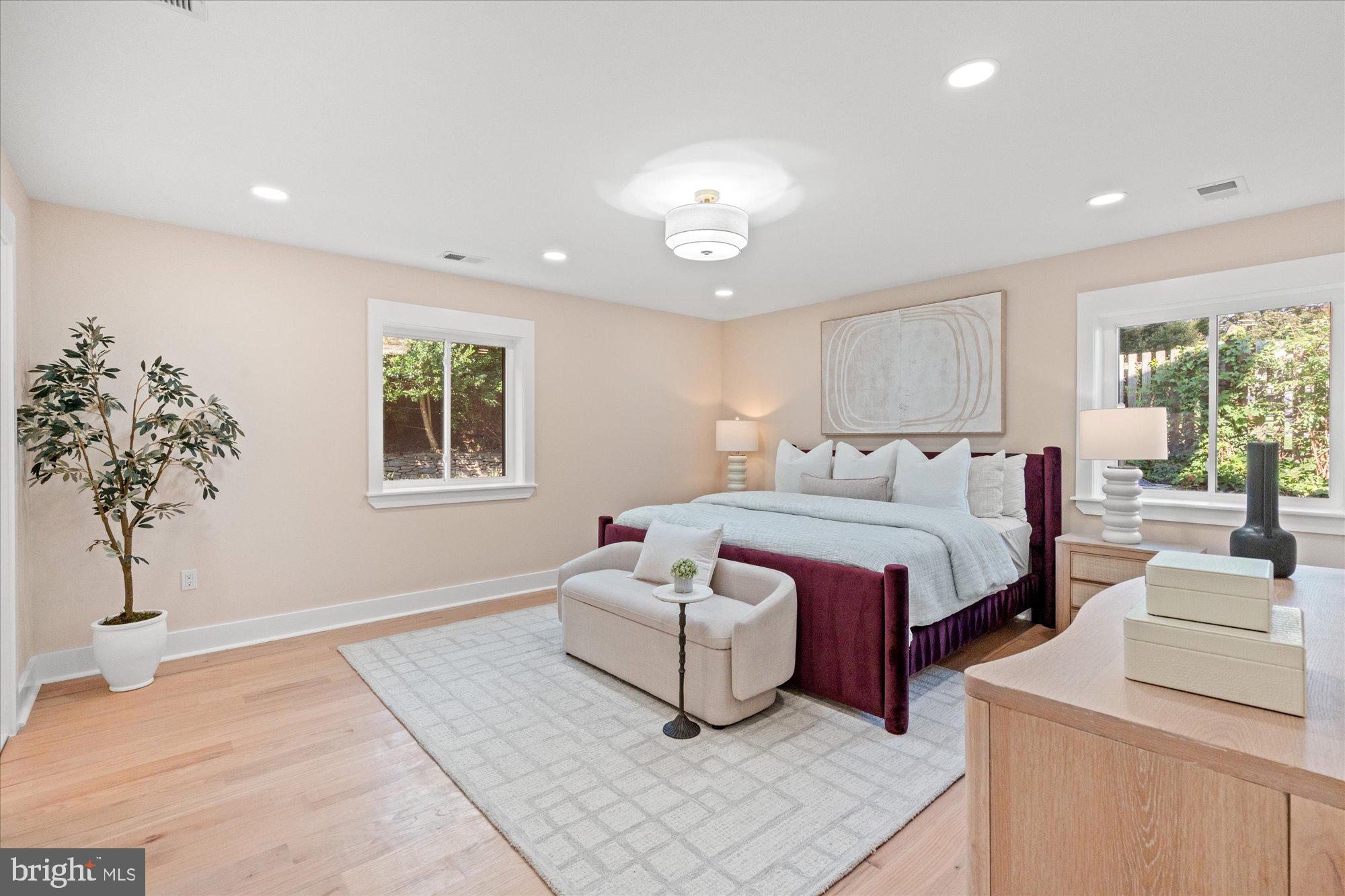 6125 Overlea Road Bethesda, MD 20816 - Photo 30 of 61 a spacious bedroom with a bed and a chandelier