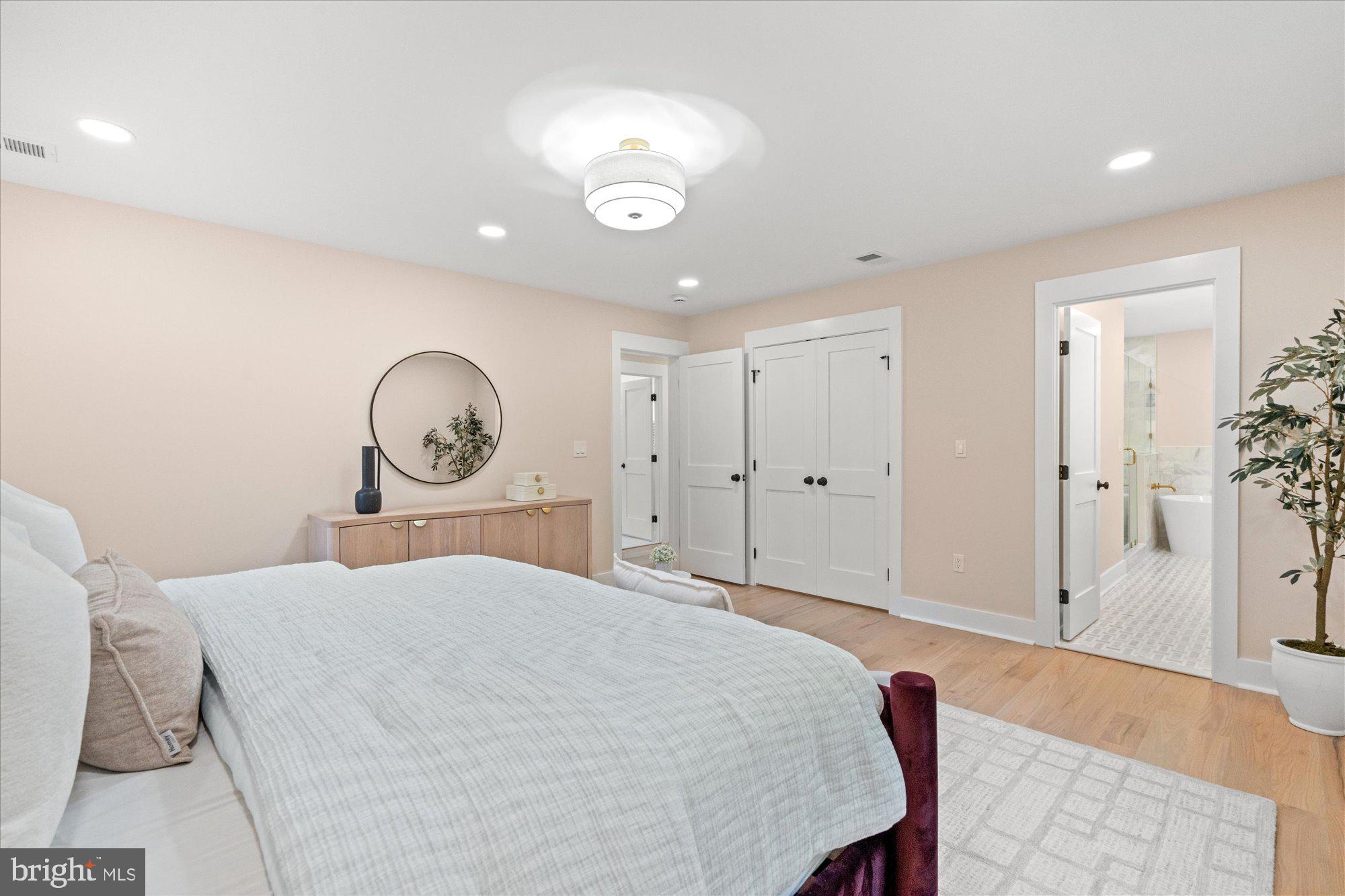 6125 Overlea Road Bethesda, MD 20816 - Photo 32 of 61 a bedroom with a bed and a chandelier