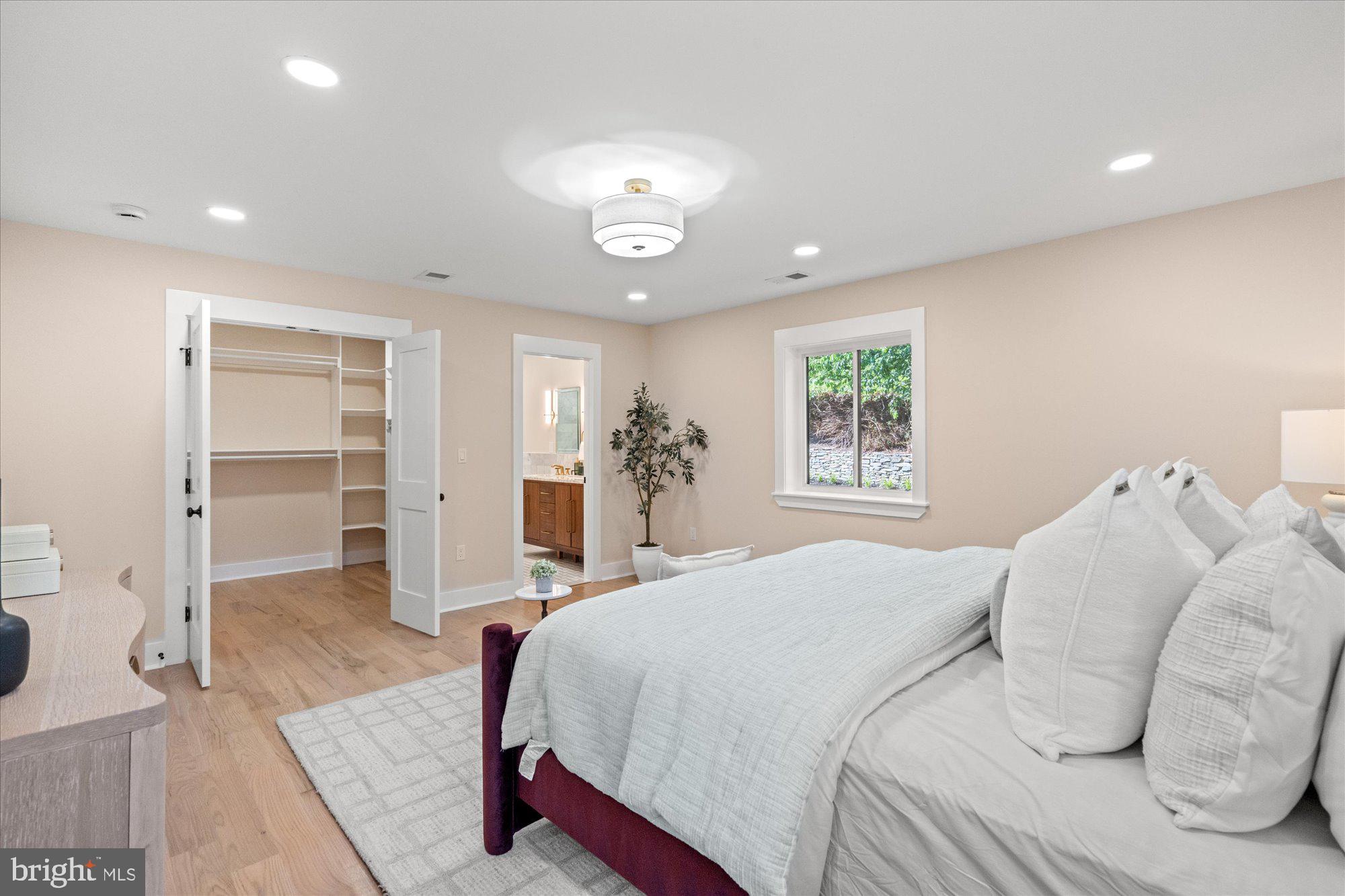 6125 Overlea Road Bethesda, MD 20816 - Photo 33 of 61 a bedroom with a large bed and chandelier